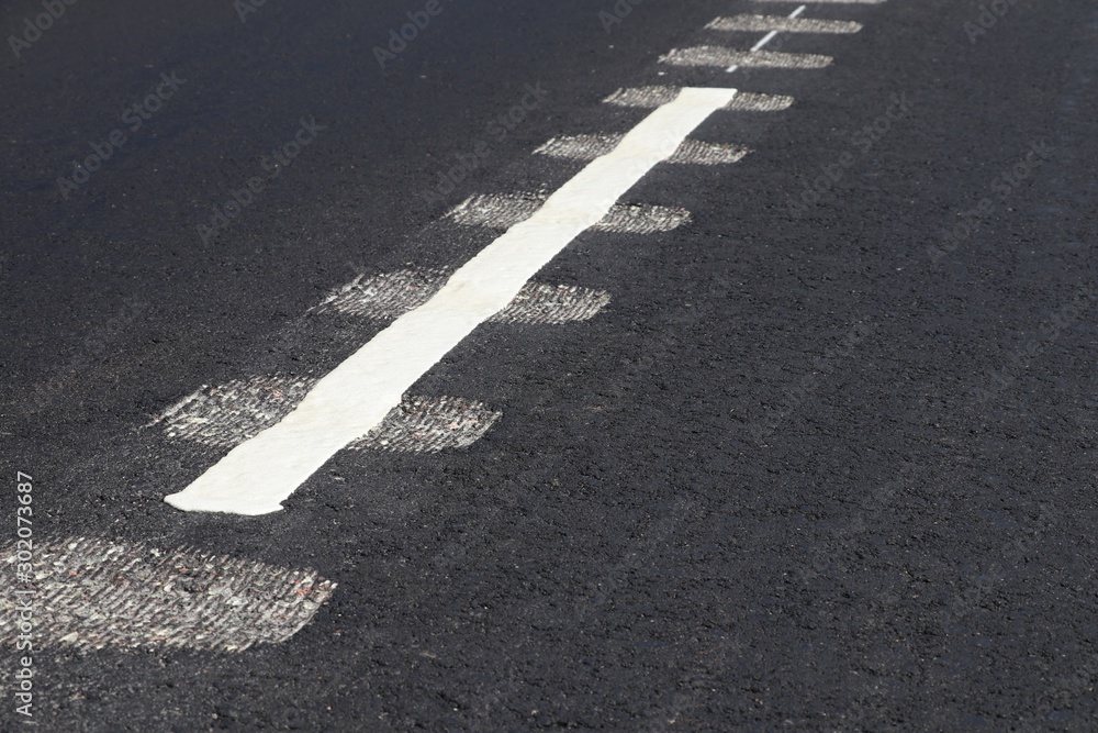 New asphalt road. Closeup view of rumble strips on a road New asphalt road. Closeup view of rumble strips on a road