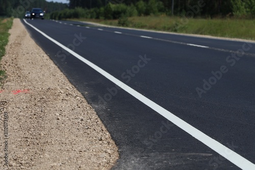 New asphalt road.   Gravel on the roadside © Alex 