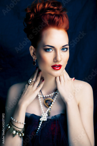 beauty stylish redhead woman with hairstyle and manicure wearing jewelry pearl close up