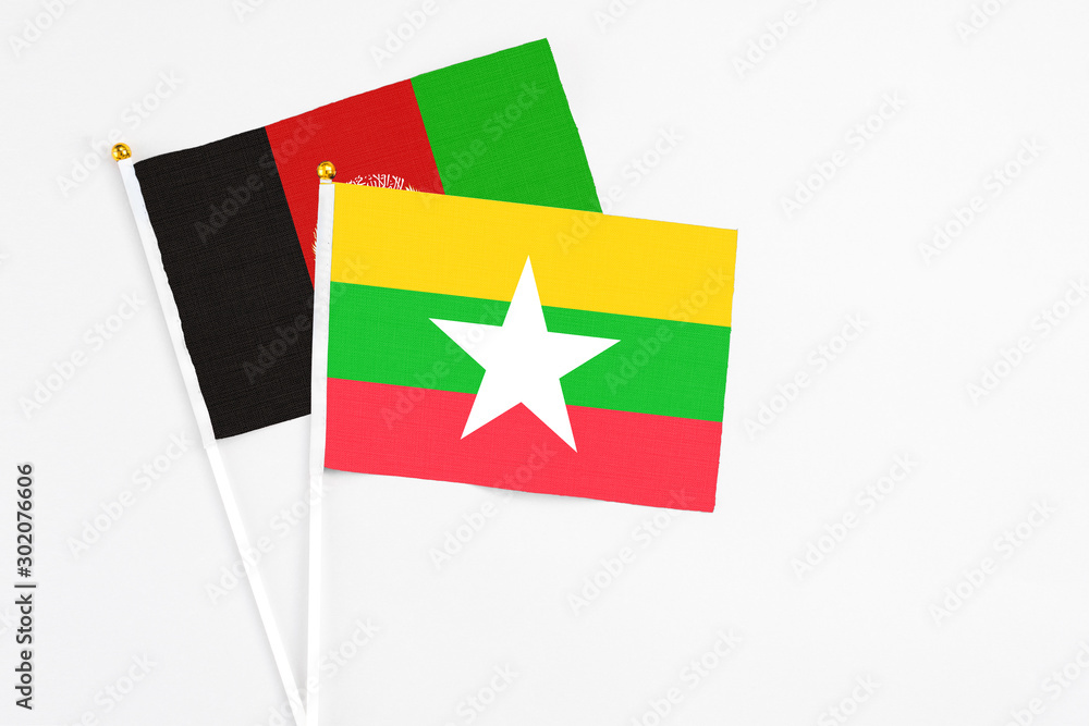 Myanmar and Afghanistan stick flags on white background. High quality fabric, miniature national flag. Peaceful global concept.White floor for copy space.