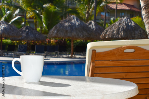 Cup of coffee table and swimming pool in hotel