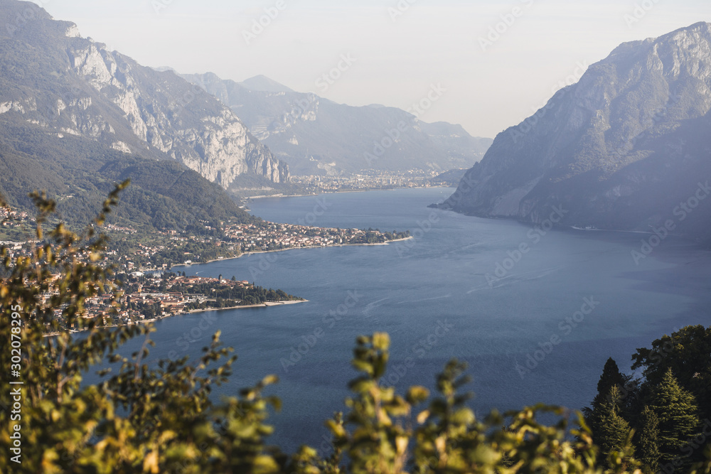 Summer postcard view of Como lake - famous and popular Italian landmark. Mountains on horizon.