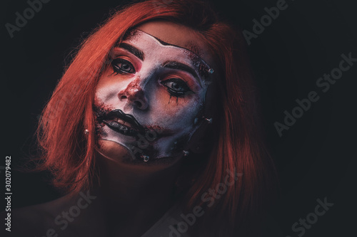 Closeup photo shoot of woman's face with creative scary makeup for Halloween. © Fxquadro