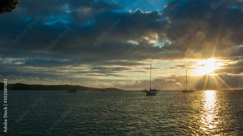 Sunset at sea with sailboat