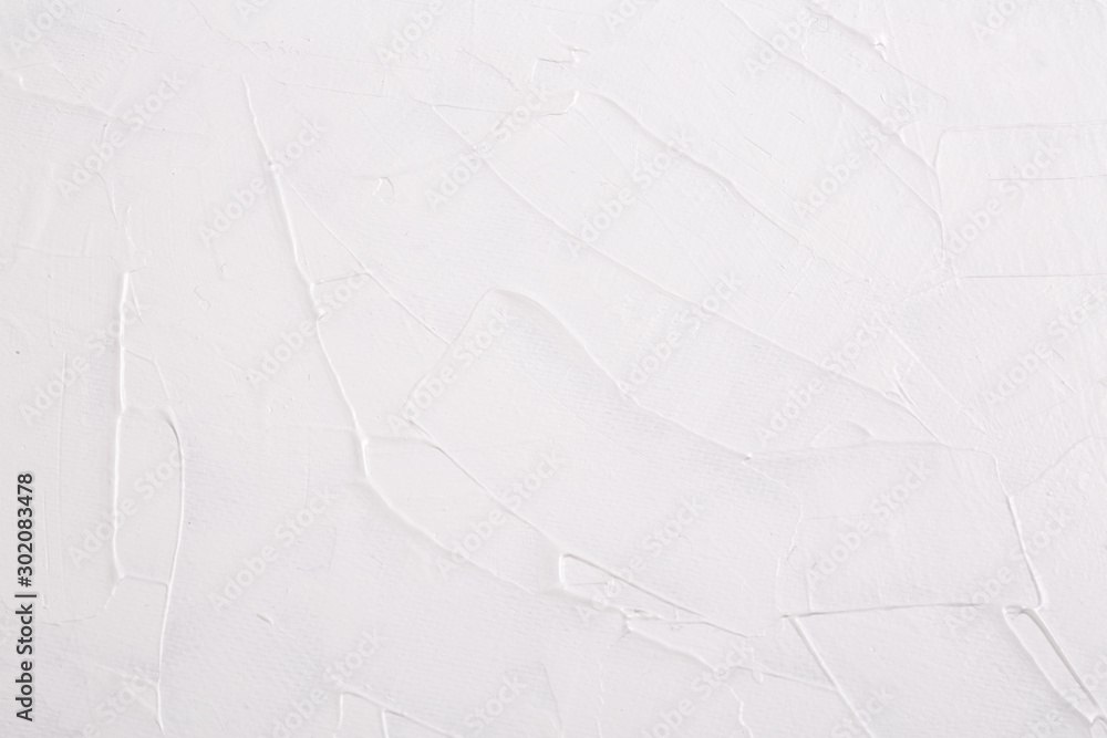 Abstract background texture of strokes of white art paint on canvas.