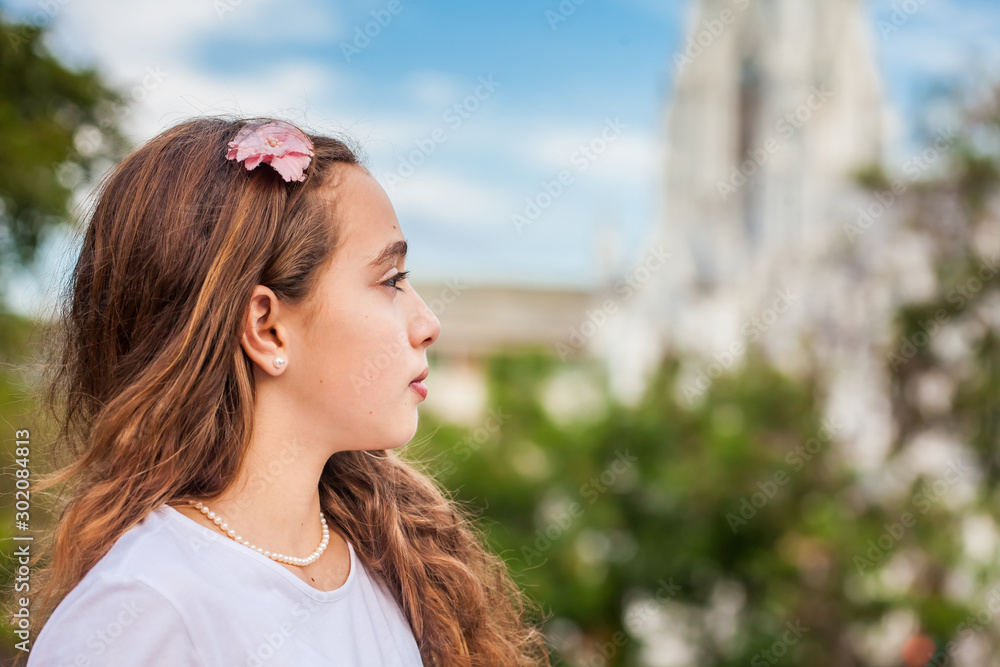 Beautiful young girl at the River Boulevard  in front of the famous gothic church of La Ermita built on 1602 in the city of Cali in Colombia - obrazy, fototapety, plakaty 