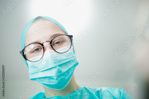 young woman dentist doctor looking at camera at patient.