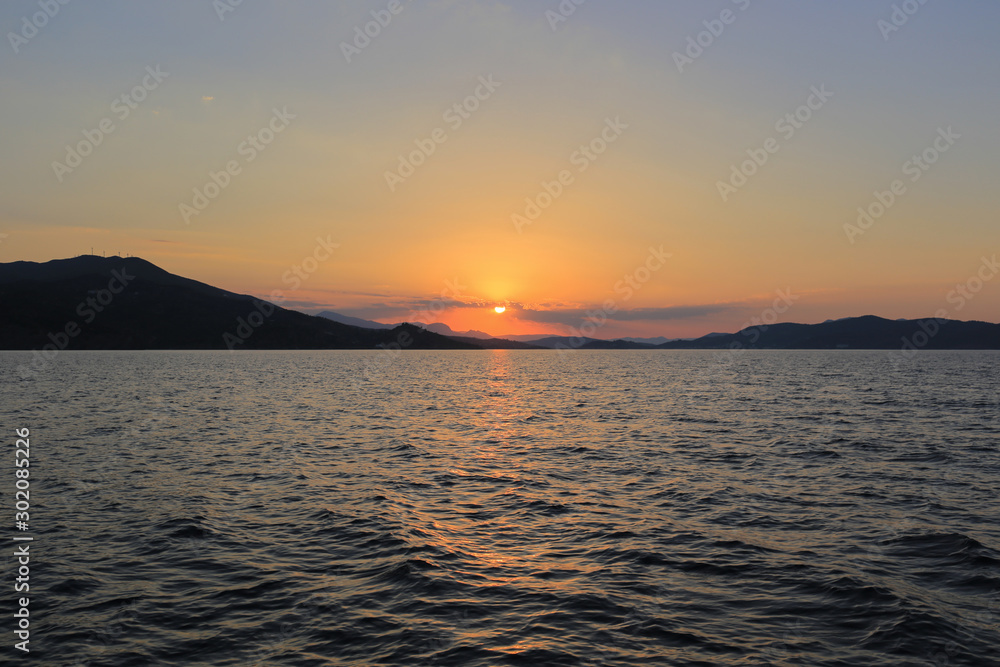 Sea view with sunset over the mountains