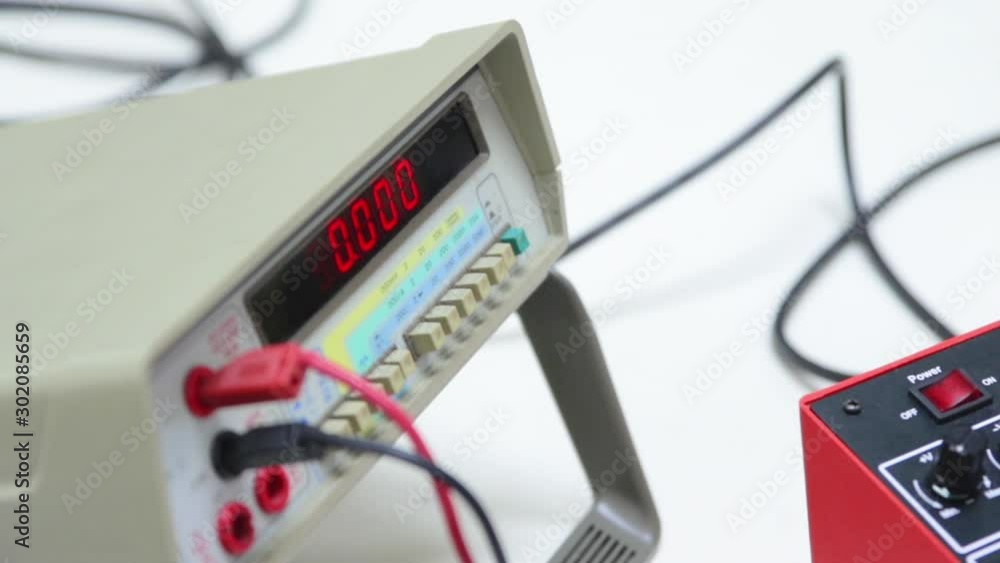 Engineering Student Using a Digital Multimeter for a Classroom Assignment. Engineering Student Using a Digital Multimeter for a Classroom Assignment.