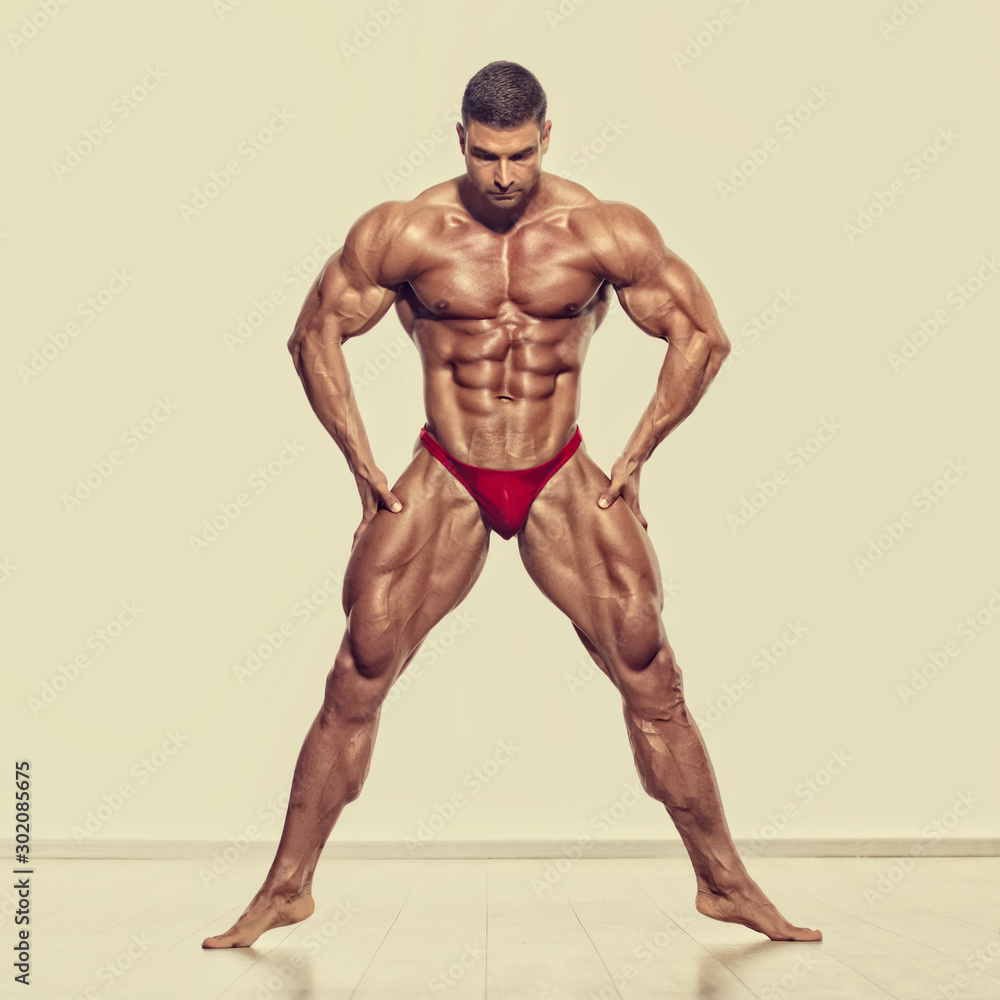 Competitive Bodybuilder Posing and Flexing Muscles