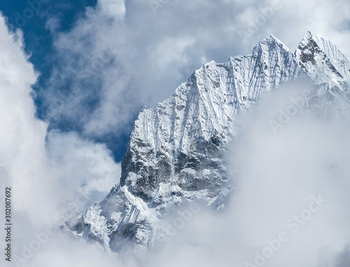 Telephoto shot of Thamserku 6608m mountain summit in the eastern Nepal Himalayas. photo