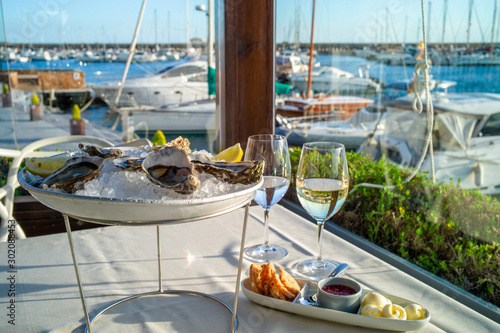 dish with oysters on a table in a restaurant with sea view