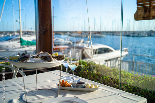 dish with oysters on a table in a restaurant with sea view