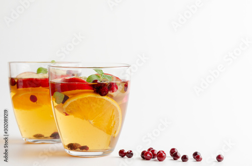Spiced apple mocktail with mint and cinnamon. White background