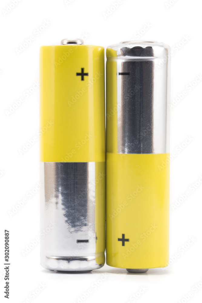alkaline batteries and a yellow metal AA-size batteries isolated on white background closeup, carbon zinc batteries, rechargeable batteries, mockup alkaline batteries and a yellow metal AA-size batteries isolated on white background closeup, carbon zinc batteries, rechargeable batteries, mockup