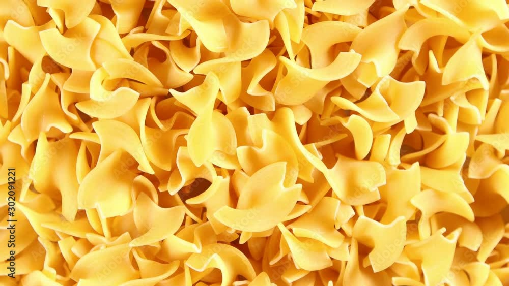 Yellow egg noodles 4k video spinning clockwise slowly top down view Yellow egg noodles 4k video spinning clockwise slowly top down view