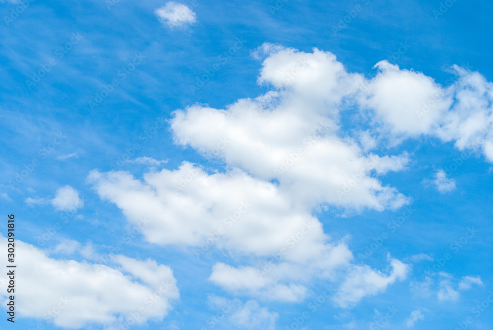 the sun shining through the clouds against the blue sky, light clouds in the sky the sun shining through the clouds against the blue sky, light clouds in the sky