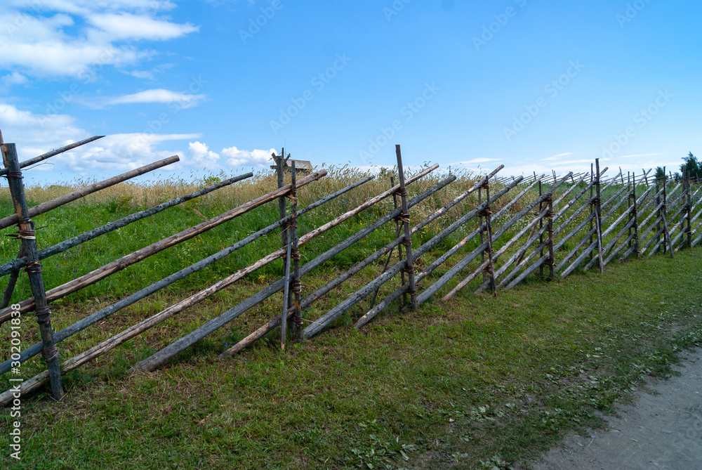 vintage old wooden fence out of sticks, made by hands