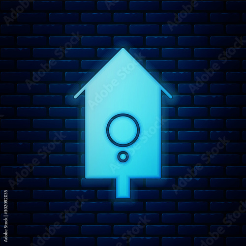Glowing neon Retro wall watch icon isolated on brick wall background. Cuckoo clock sign. Antique pendulum clock. Vector Illustration
