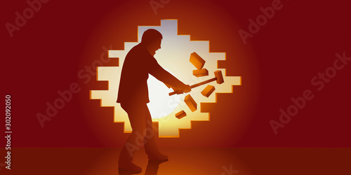 Fotografia Concept de la liberté, avec un homme qui ouvre une brèche dans un mur pour s’échapper de sa prison et passer de l’ombre à la lumière