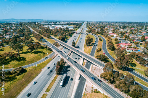 Straight highway passing through interchange in Melbourne, Australia - aerial view