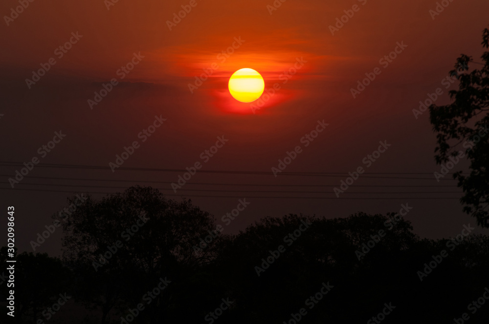sunset in the brazilian cerrado with powerlines
