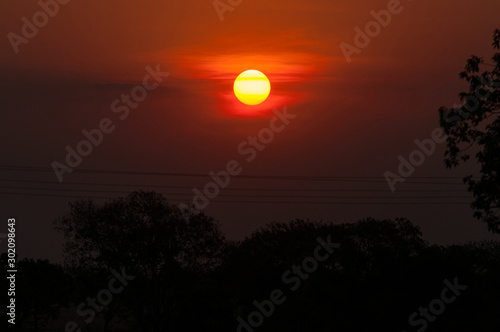 sunset in the brazilian cerrado with powerlines