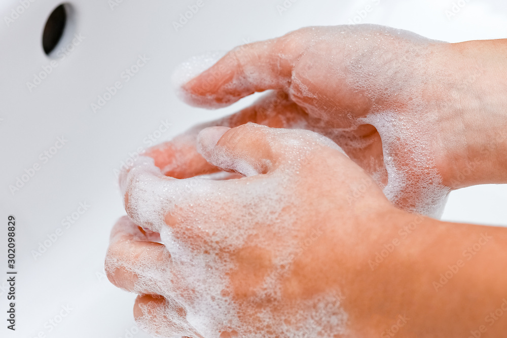 Hygiene concept. Washing hands with soap under the faucet with water Hygiene concept. Washing hands with soap under the faucet with water
