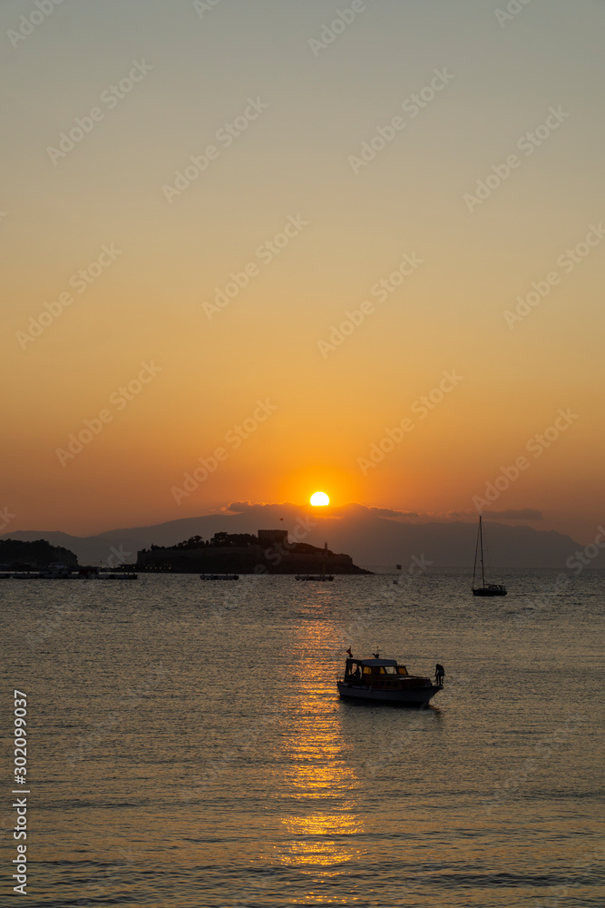 View of the coast of Kusadasi, Turkey. Sunset over the port in the tourist town.