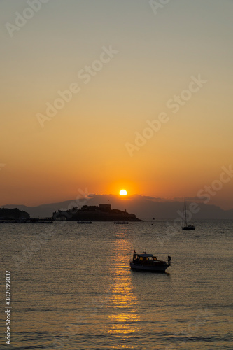 View of the coast of Kusadasi, Turkey. Sunset over the port in the tourist town.