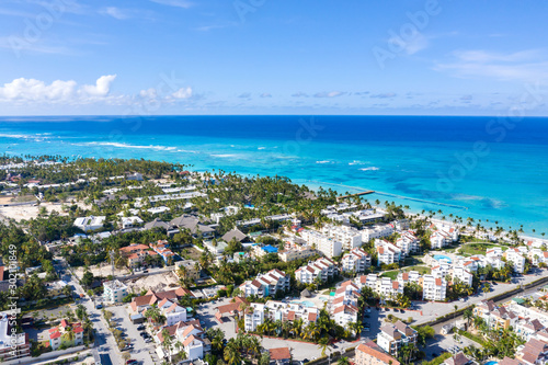 Caribbean city on tropical coastline. Aerial view from drone
