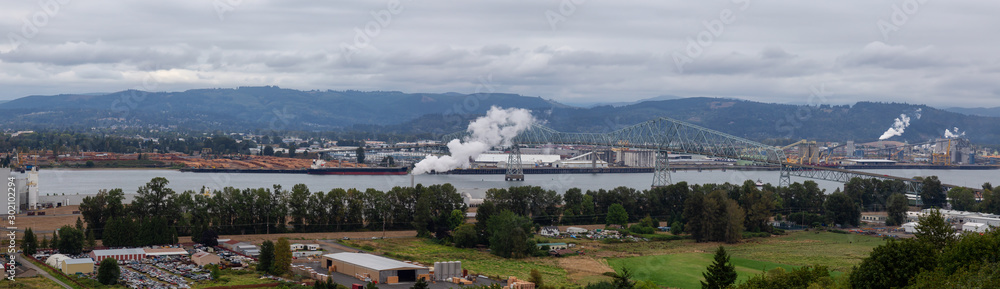 Obraz premium Longview, Washington, United States of America. Aerial Panoramic View of Port, Industrial Sites and Lewis and Clark Bridge over Columbia River.