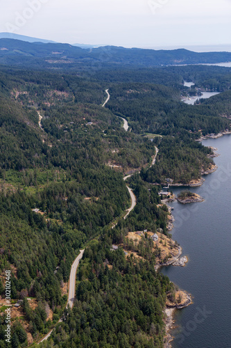 Sunshine Coast, British Columbia, Canada. Aerial View of a windy highway on the coast during a sunny and hazy summer morning. © edb3_16