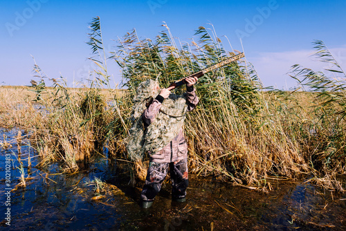 excellent hunter disguise - a lone hunter hid in the reeds awaiting prey