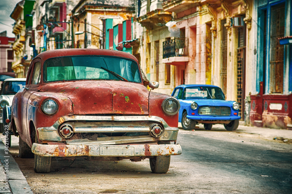 Havana street in Cuba with old red american car