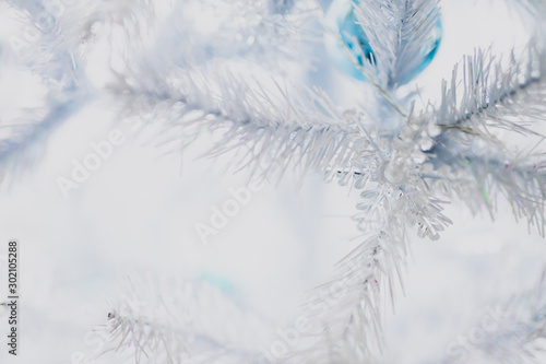 Christmas tree with white frosted snow style with snowflakes decorations and blue and silver baubles