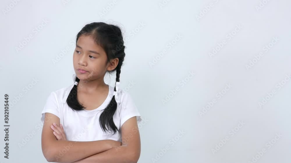 A girl wearing a white shirt, braid, and a lovely white ribbon tie, was thinking and finally formed an idea. Smiling and pointing the hand towards the opposite side for placing advertising or banner A girl wearing a white shirt, braid, and a lovely white ribbon tie, was thinking and finally formed an idea. Smiling and pointing the hand towards the opposite side for placing advertising or banner