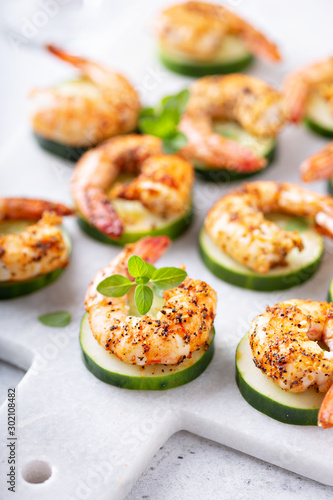 Fototapeta Spicy shrimp and cucumber, New Years Eve or Christmas party appetizer