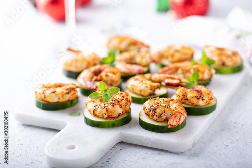 Fotografering Spicy shrimp and cucumber, New Years Eve or Christmas party appetizer