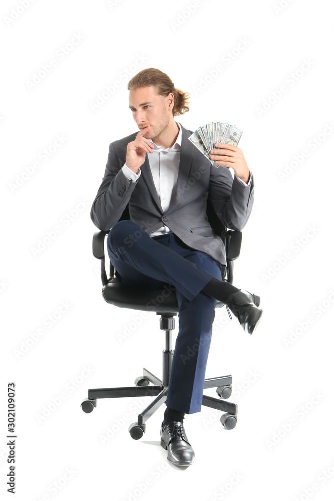 Thoughtful young businessman with money sitting on chair against white background Thoughtful young businessman with money sitting on chair against white background