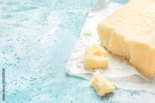 Tasty Parmesan cheese on color background, closeup