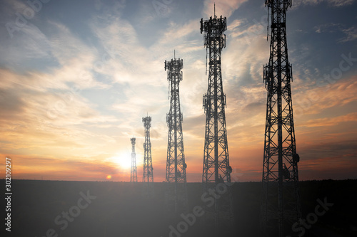 Fototapeta Antenna The signal tower has a sunset background.