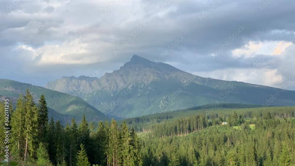 Krivan Peak Mountain on Sunny Cloudy Day, Pine Tree Forest, High Tatras Slovakia Krivan Peak Mountain on Sunny Cloudy Day, Pine Tree Forest, High Tatras Slovakia