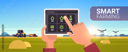 farmer hands using tablet controling tractor and drone sprayer on field smart farming modern technology organization of harvesting application concept landscape background horizontal copy space vector