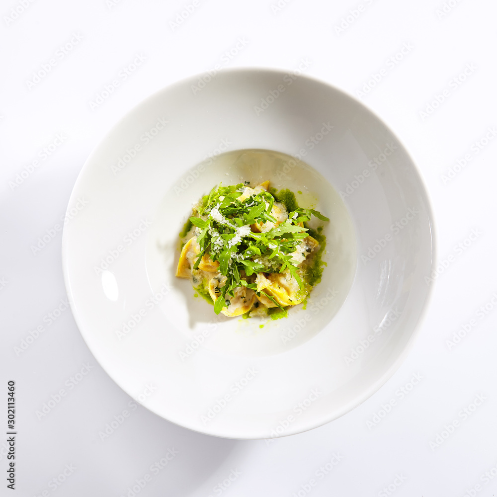Tortellini with rabbit meat pesto sauce and arugula Tortellini with rabbit meat pesto sauce and arugula