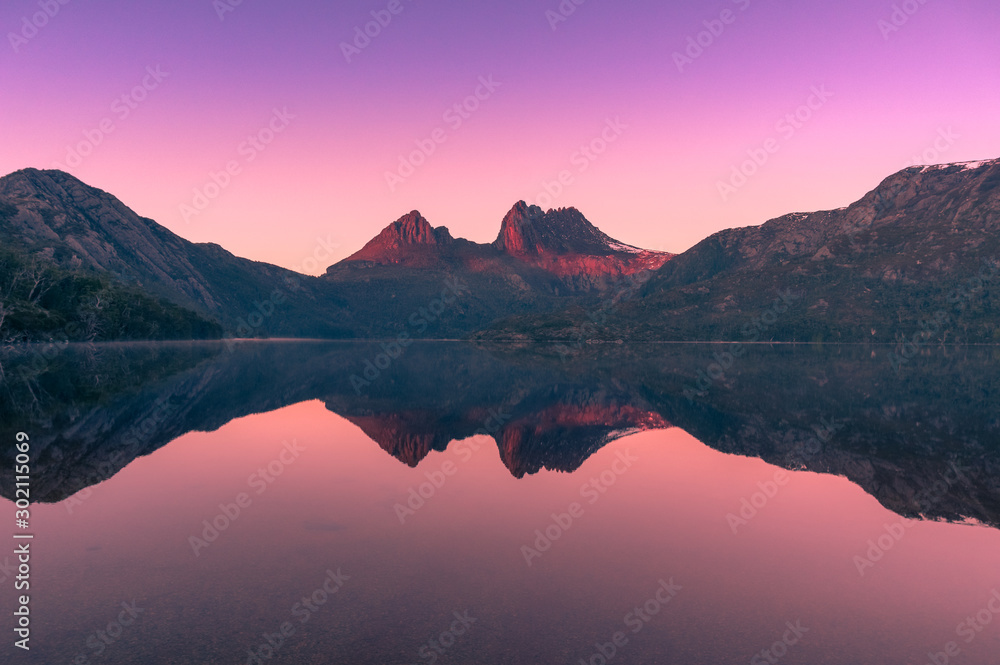 Picturesque nature background with Cradle Mountain and lake at sunrise