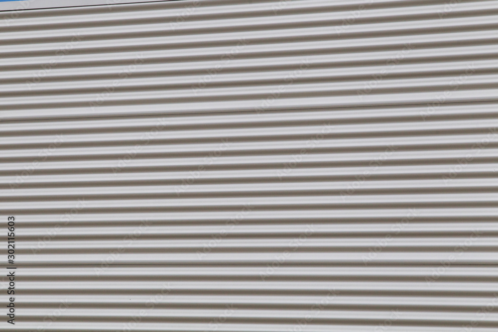 Wide shot of silver corrugated metal with bolts Wide shot of silver corrugated metal with bolts