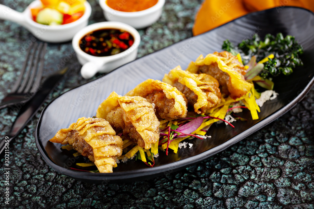 Deep fried potstickers or dumplings with dipping sauces Stock Photo