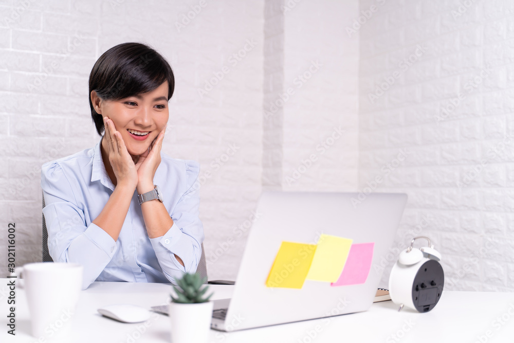 Happy woman sitting at home office working using computer laptop Happy woman sitting at home office working using computer laptop