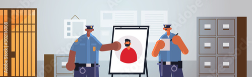 mix race policemen officers couple looking at board with thief photo security authority justice law service concept modern police department interior flat portrait horizontal vector illustration